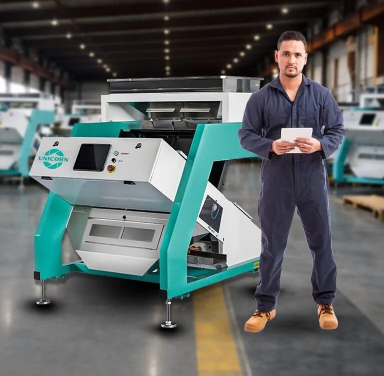 Technician standing with a cashew color sorting machine